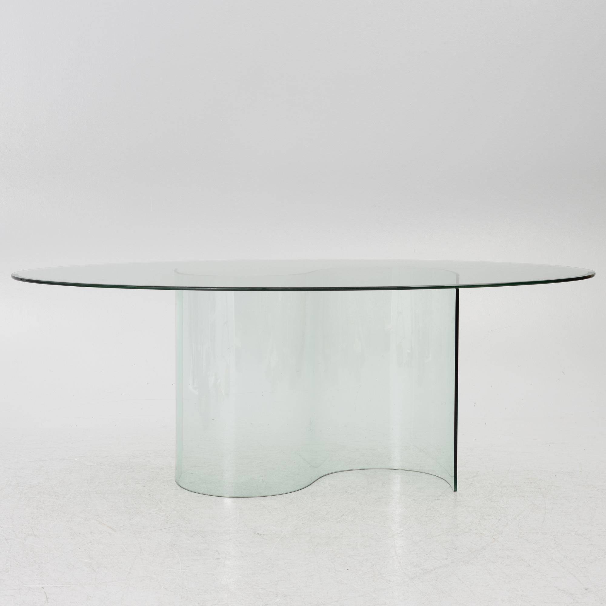 A dining table, glass, contemporary.