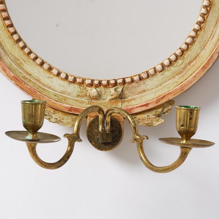 A pair of Gustaviantwo-branch giltwood girandole mirrors by C. G. Fyrwald (master in Stockholm 1776-1825).