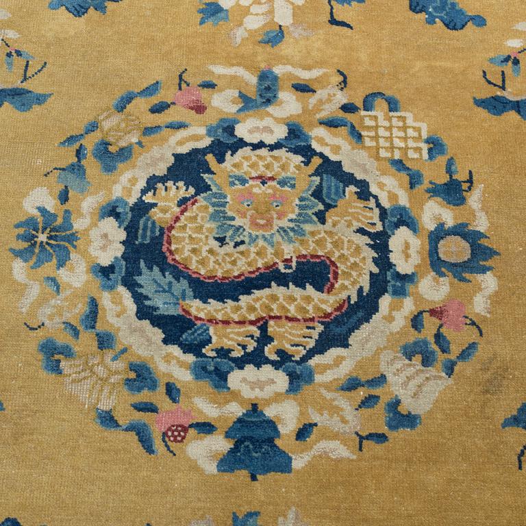 A semi-antique chinese carpet, around  320 x 245 cm.