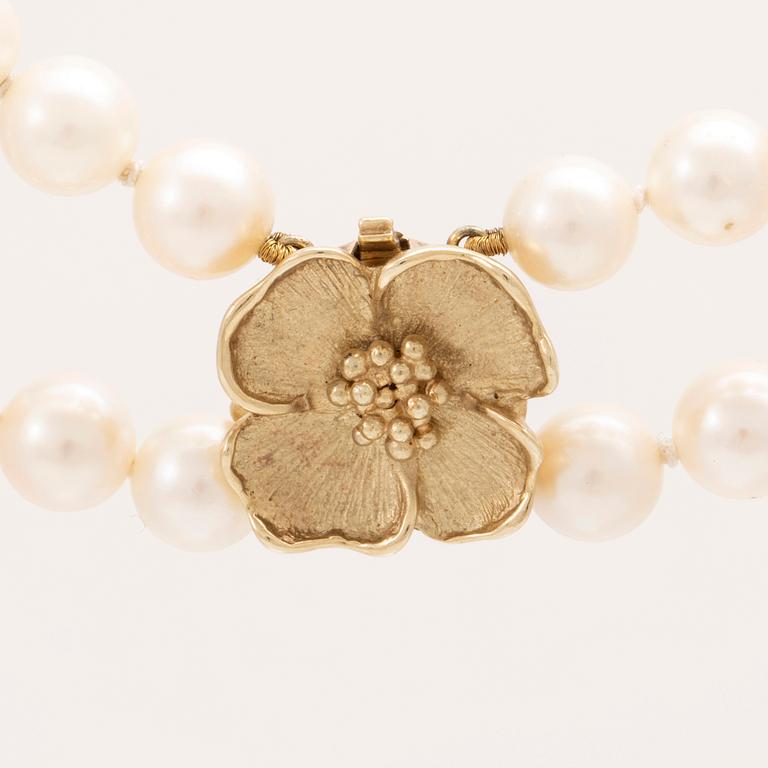 A two row cultured pearl necklace with 14K gold clasp.