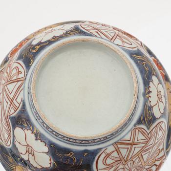 A Chinese dinner plate and a Japanese imari bowl, 18th Century together with a Chinese 19th Century jar with cover.