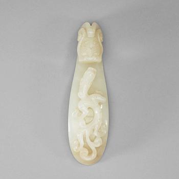 25. A carved white nephrite belt hook, Qing dynasty (1644-1912).