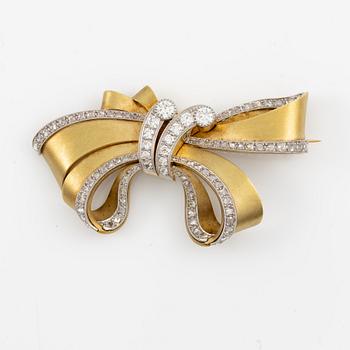 Bow brooch in 18K gold and platinum set with round brilliant, eight-cut, and rose-cut diamonds.