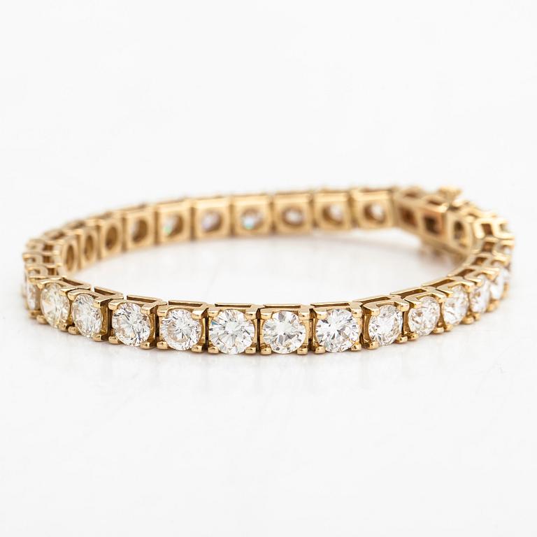 A 14K gold tennis bracelet, with brilliant-cut diamonds totalling approximately 12.00 ct.