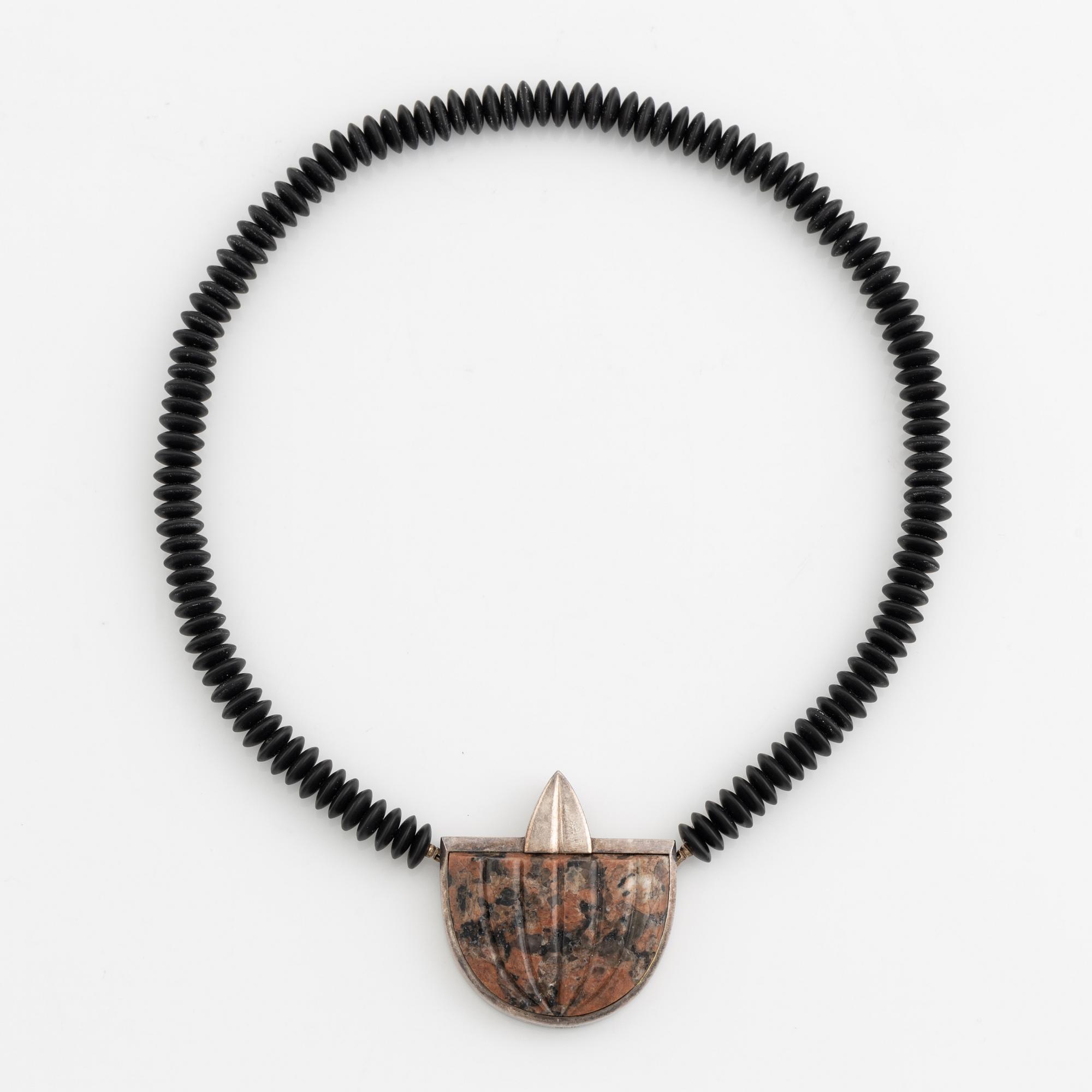 Gaudy necklace, silver and carved stone.