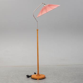 A 1940s birch wood floor lamp.