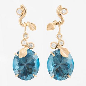 Earrings with blue topazes and brilliant-cut diamonds.