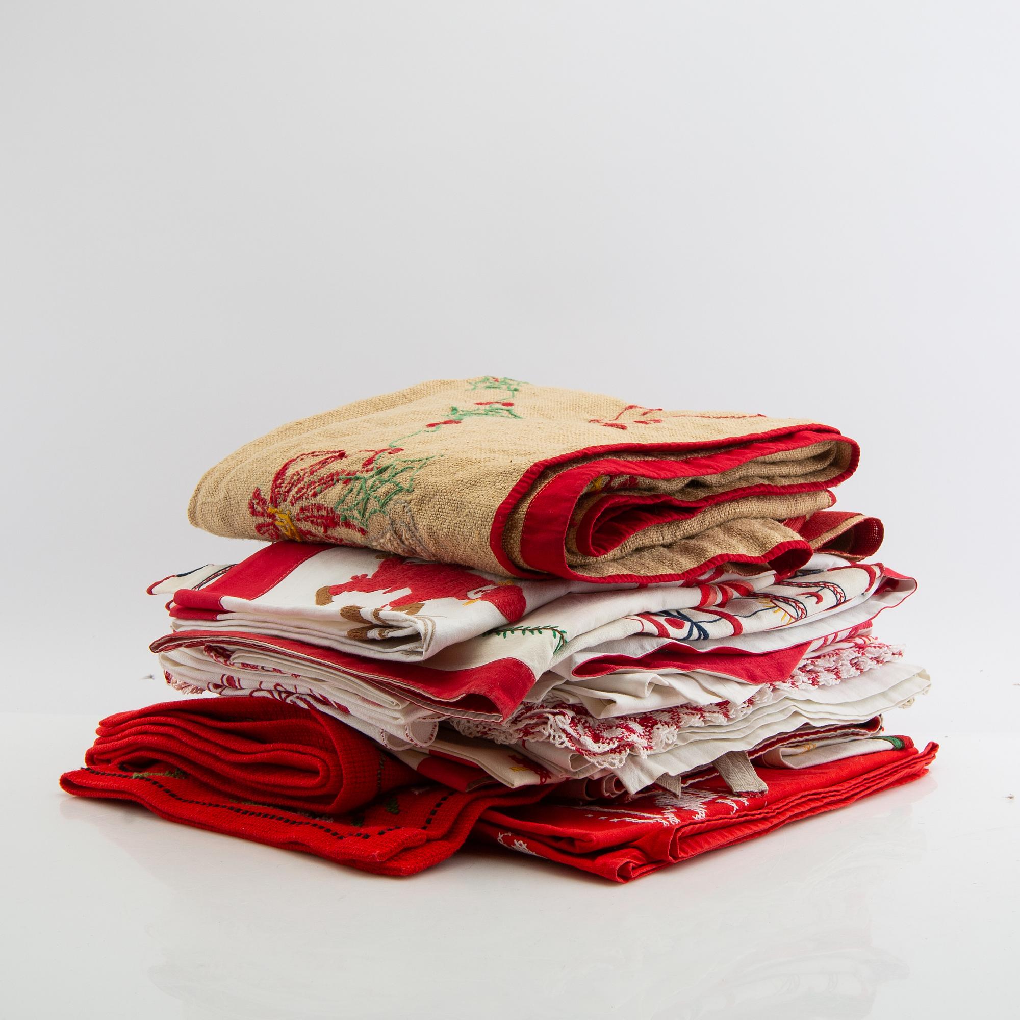 A collection of Christmas tablecloths, Christmas tree skirts, an apron, and runners, 21 pcs, 20th century.