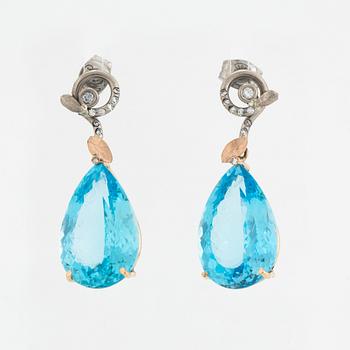Drop shaped blue topaz and diamond earrings.