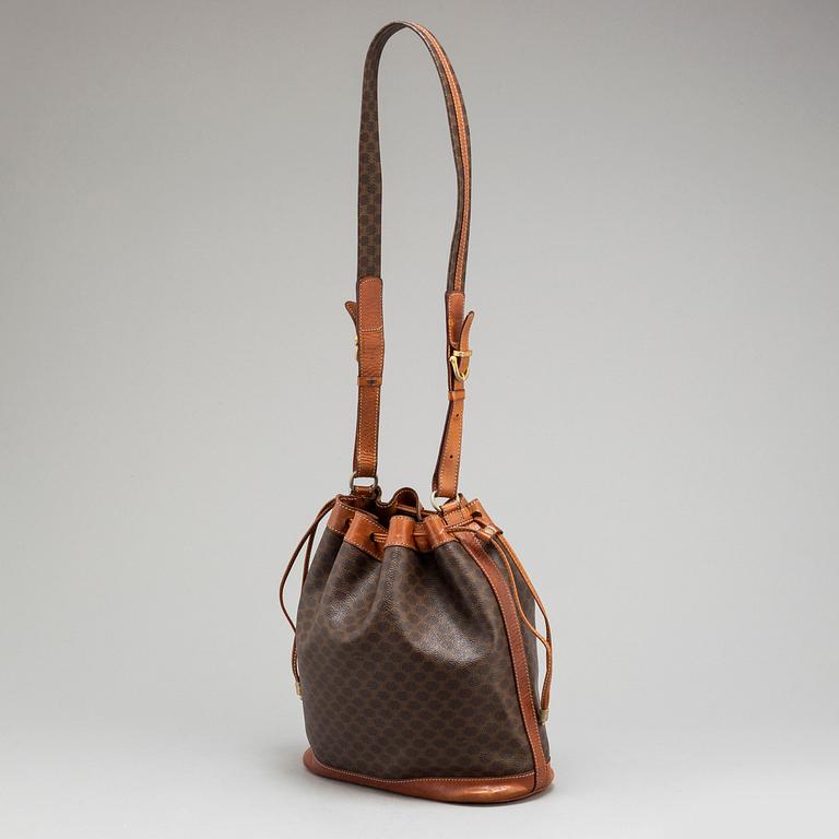 CÉLINE, a monogram canvas bucket bag.