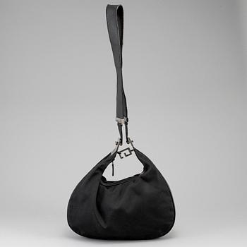 GUCCI, a canvas handbag.