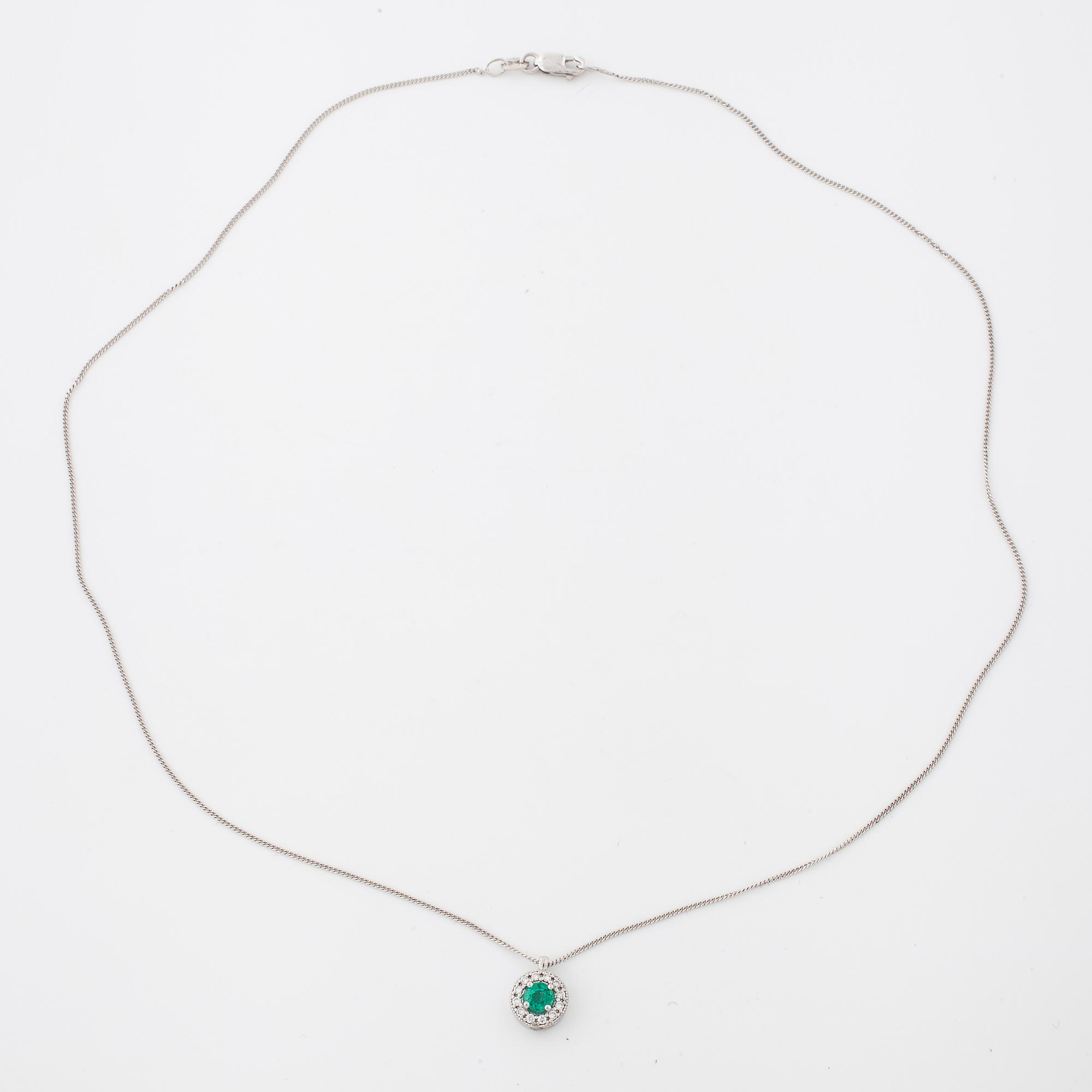 An emerald and brilliant cut diamond pendant.
