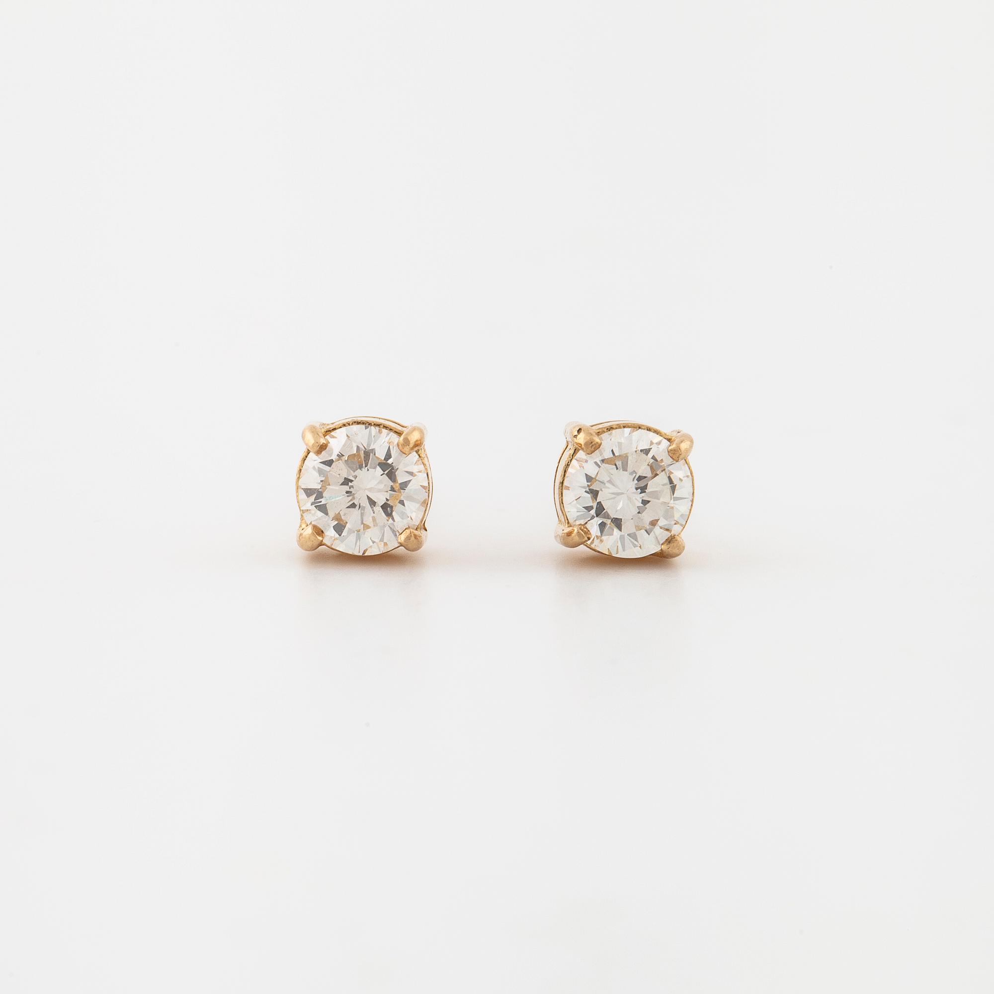A pair of brilliant cut diamond earrings.