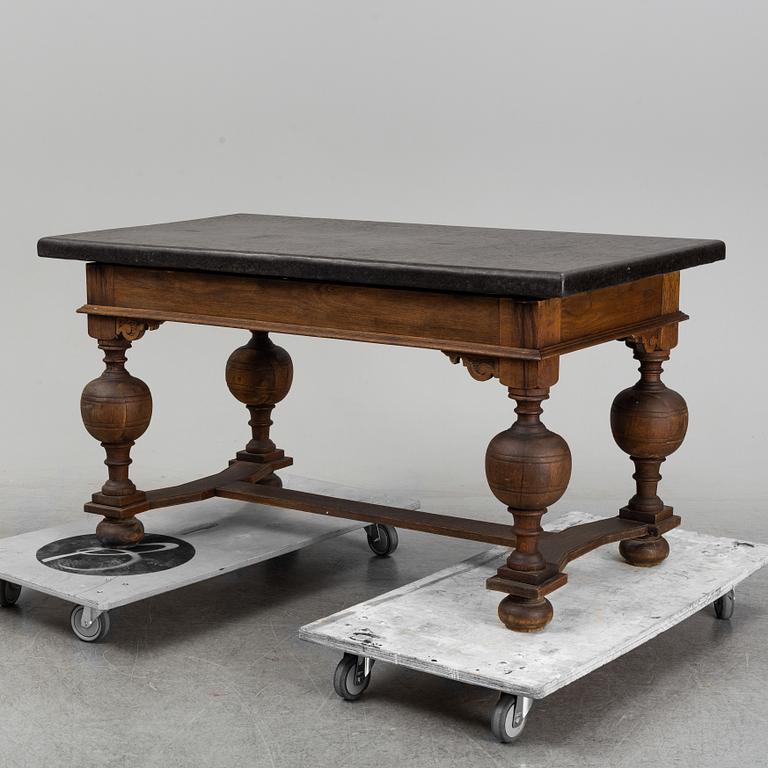 A 19th Century Baroque style table with a stone top.