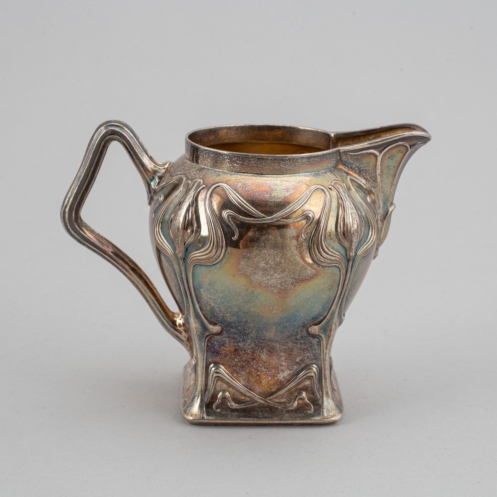 An art nouveau silver coffee pot, sugar bowl and creamer, mark of CF Källström, Malmö 1901.