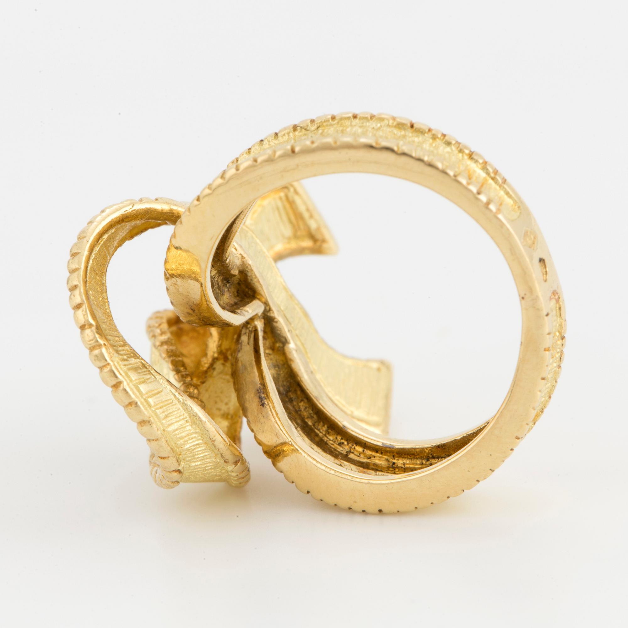 An 18K gold bow ring with French hallmarks.
