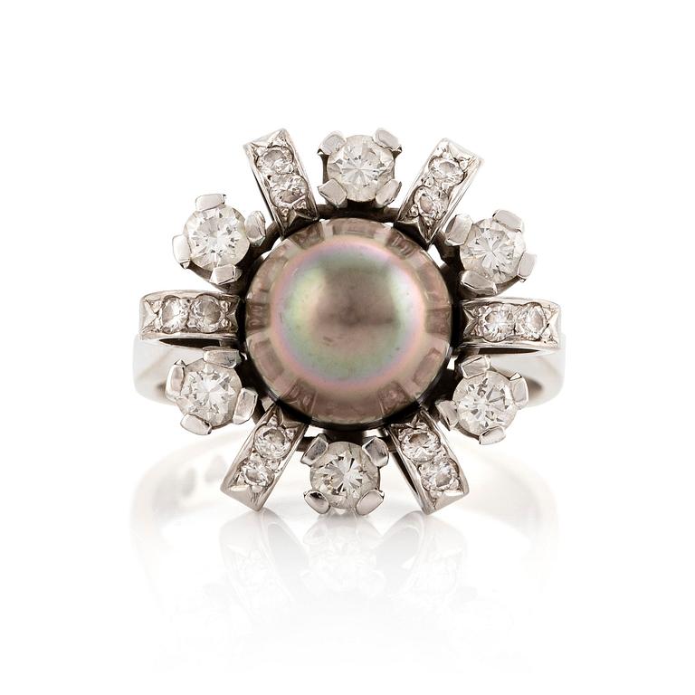 An 18K white gold ring set  with a pearl and round brilliant-cut diamonds.