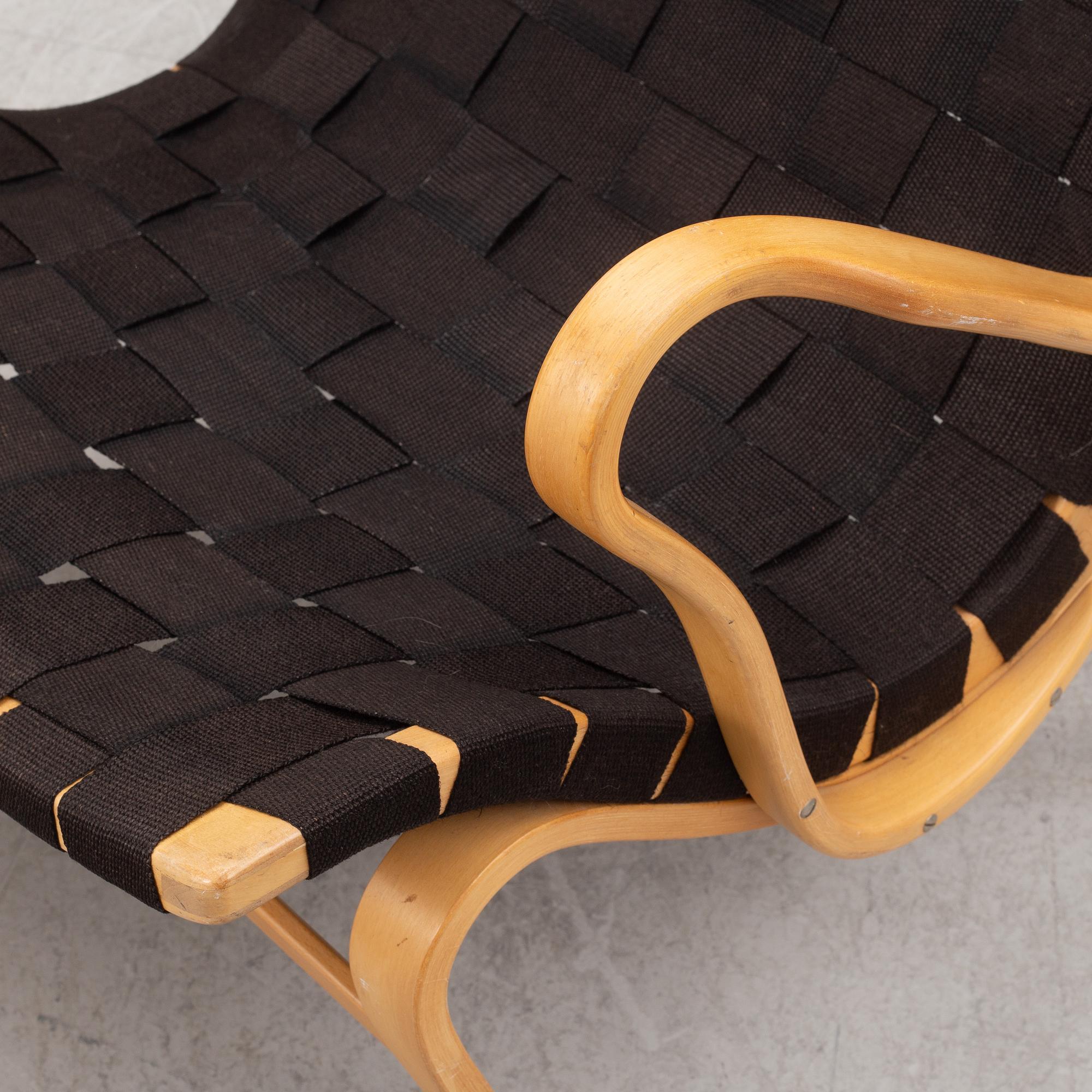 Bruno Mathsson, a "Pernilla" armchairs with ottoman, Dux, Sweden, second half of the 20th century.