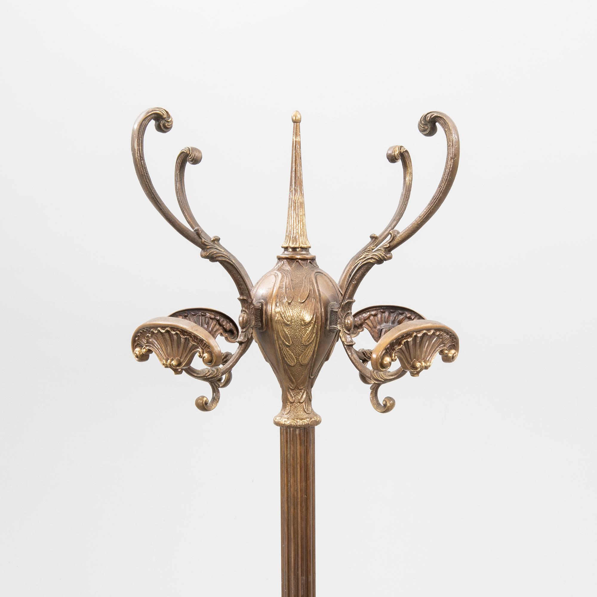 A brass coat hanger from the first half of the 20th century.