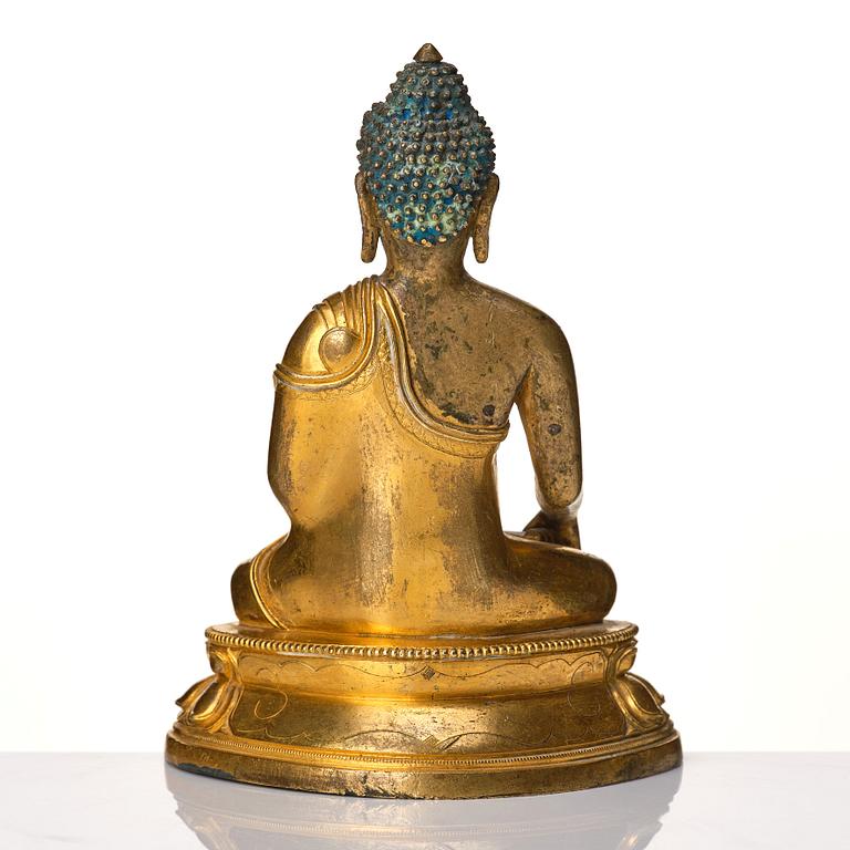A Tibeto Chinese style gilt copper alloy figure of Buddha.