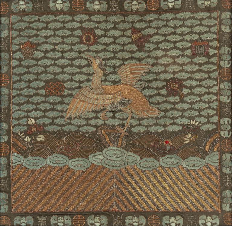 An embroidered civil official's rank badge with a bird, 'buzi', Qing dynasty.