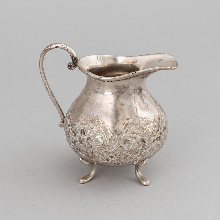 A Pakistan silver coffee pot, sugar bowl, sugar tongs and creamer.