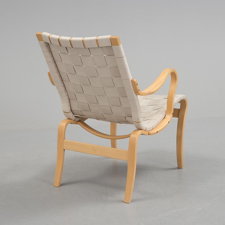 An "Mina" armchair by Bruno Matsson.