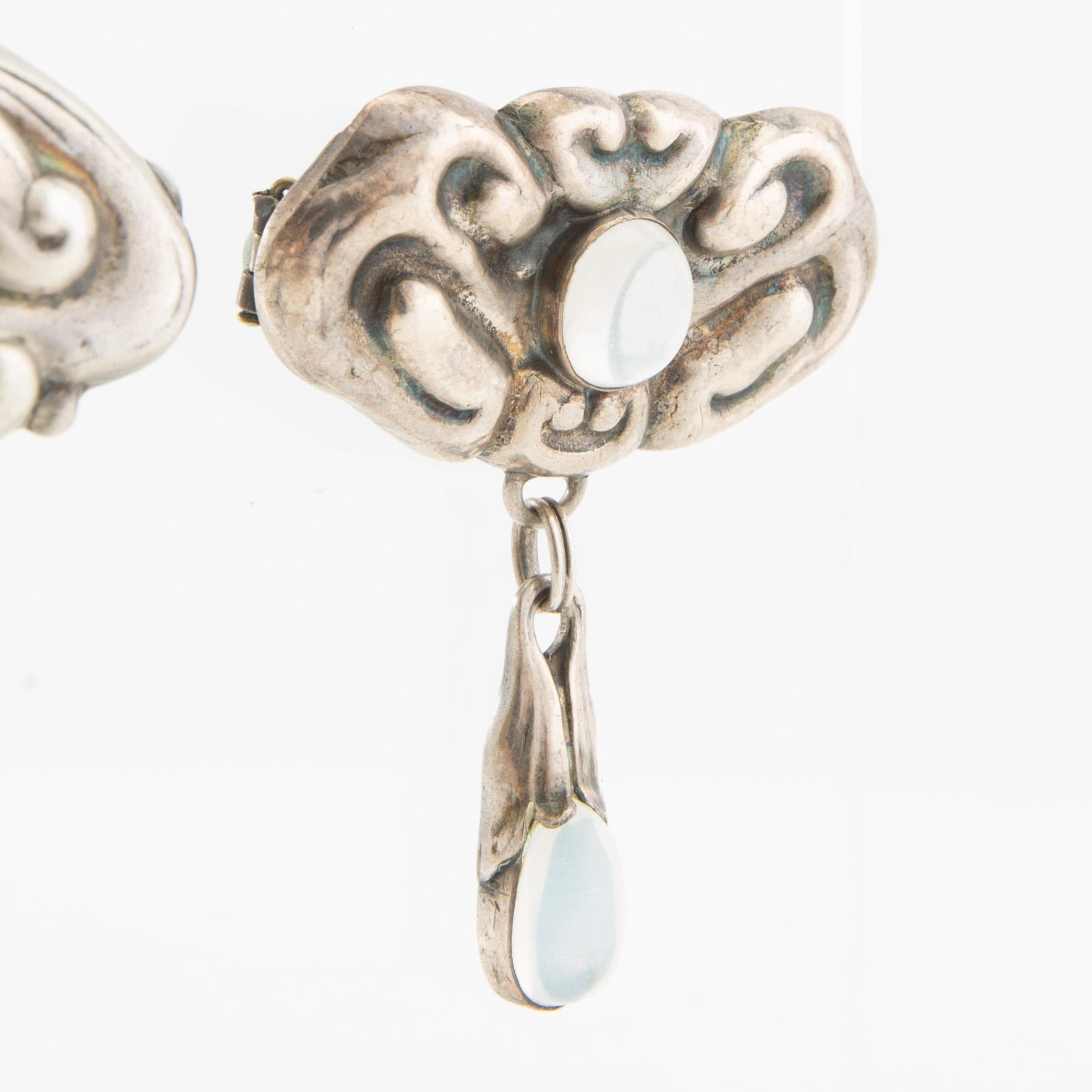 Brooches, 2 pieces, Art Nouveau, early 20th century, pewter, moonstone, and green stone.