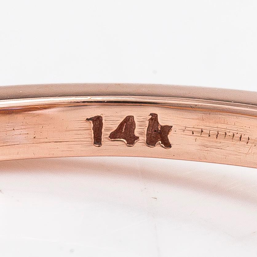 A 14K rosegold ring with a sapphire and diamonds ca 0.12 ct in total.