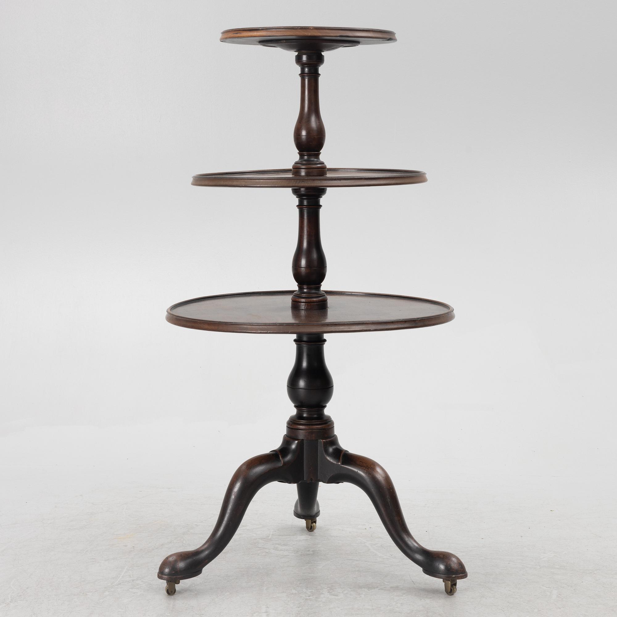 A mahogany three-tier table, England, circa 1900.