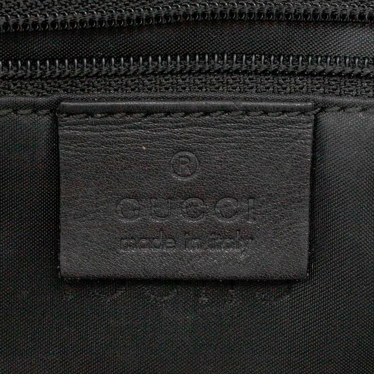 GUCCI, a canvas handbag.