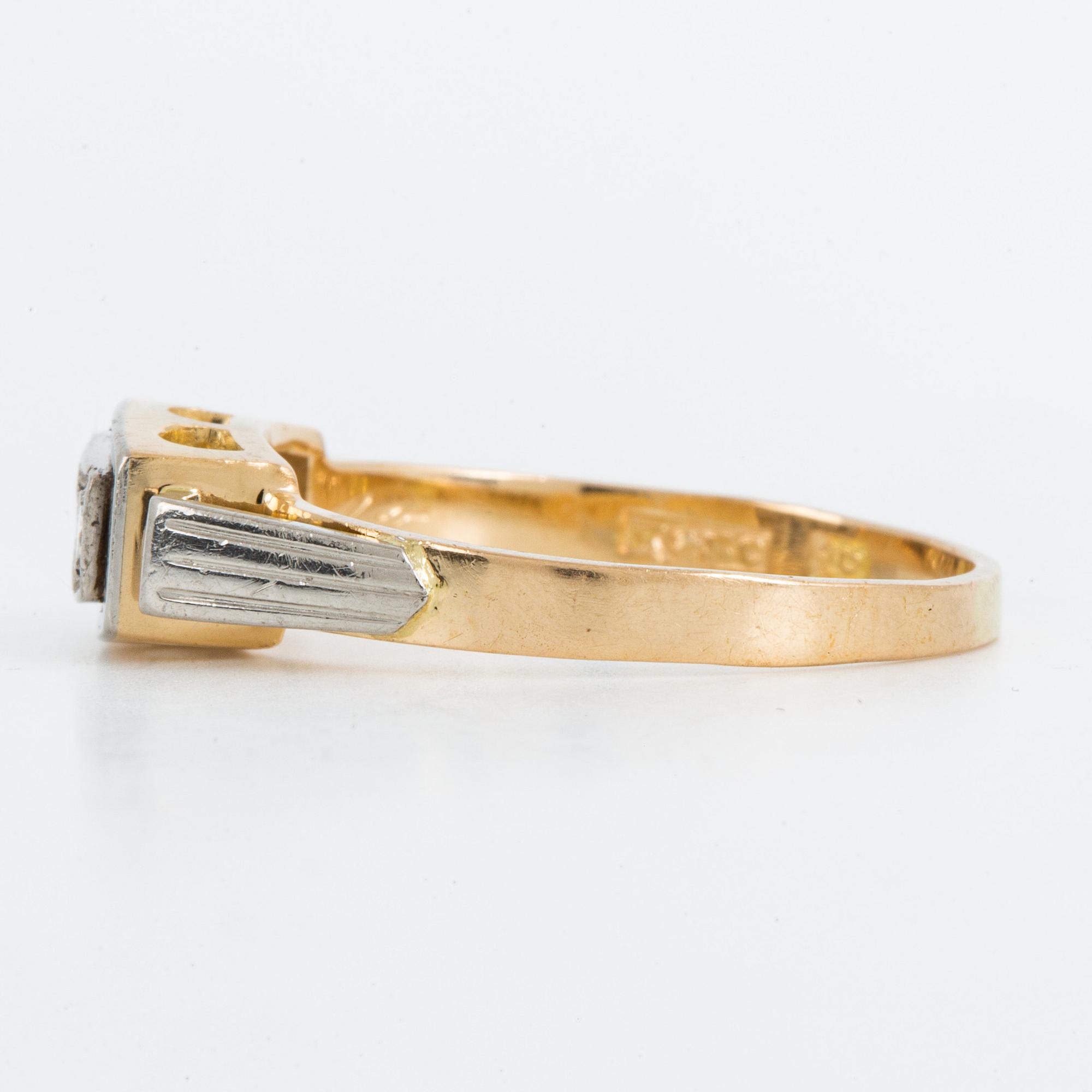 18K gold and brilliant-cut diamond three-stone ring.