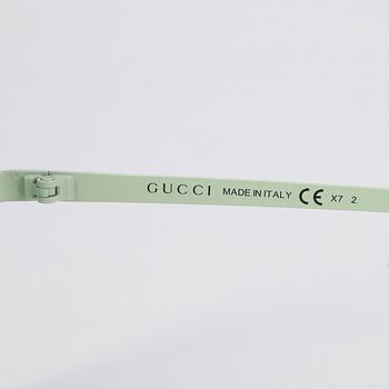 GUCCI, a pair of sunglasses.