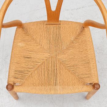 Hans J. Wegner, four model CH-24/ 'Wishbone' chairs, Carl Hansen, Odense, Denmark, second half of the 20th century.