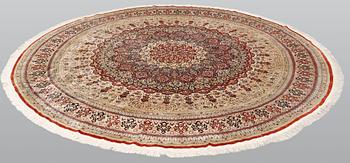 An Oriental silk rug, diameter 256 cm.