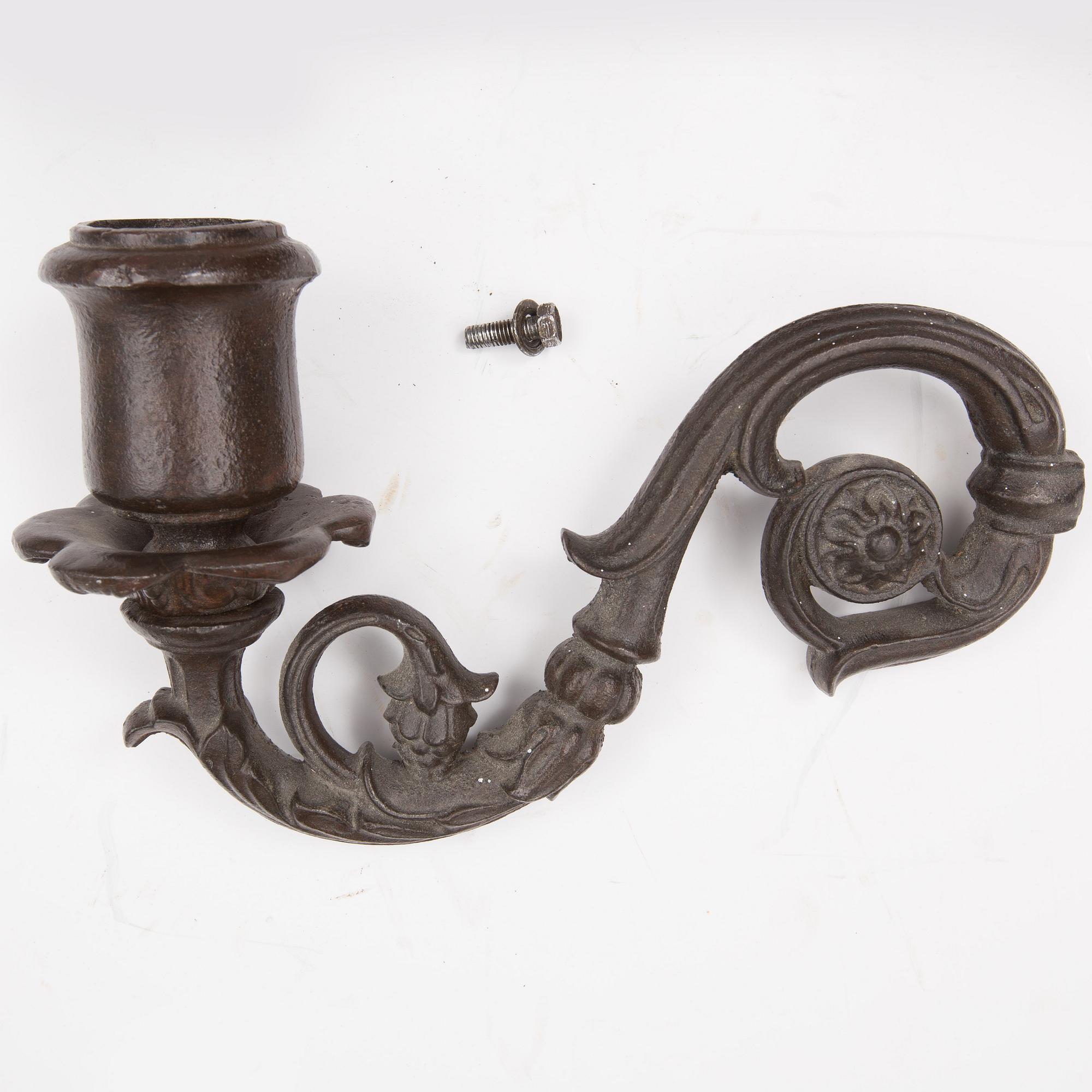 An early 20th century cast iron vall sconce candleholder for five candles.