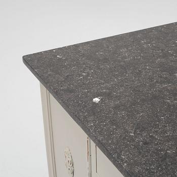 A painted dresser with a stone top, from around the year 1900.