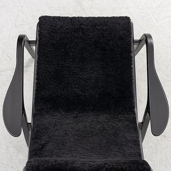 Yngve Ekström, a  'Lamino' easy chair with foot stool, Swedese, 2018.
