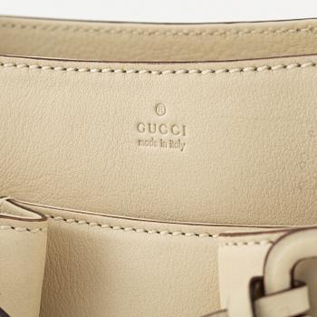 Gucci, a leather handbag.