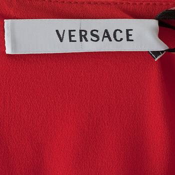 VERSACE,  a red silk dress with beige lacquer decor.