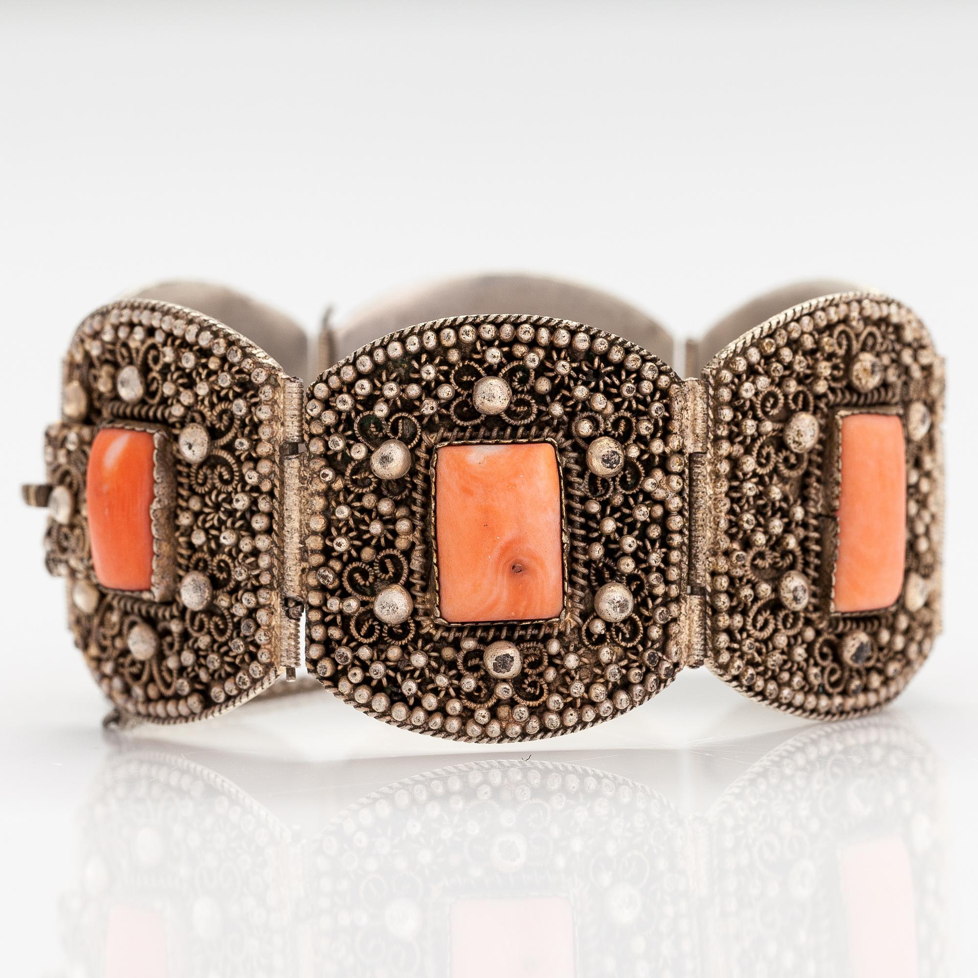A silver bracelet with corals.