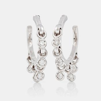 1317. A pair of Dior white gold hoop earrings with 5 suspending brilliant-cut diamonds on each earring.