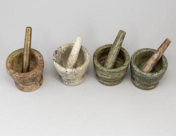 Four swedish green marble mortars and pestles, early 19th century.