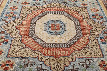 An oriental carpet with Mamluk design, c. 356 x 255 cm.