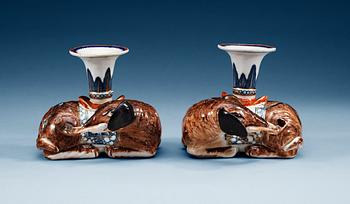 A pair of famille rose candlesticks in the shape of elephants, Qing dynasty, Qianlong (1736-95).