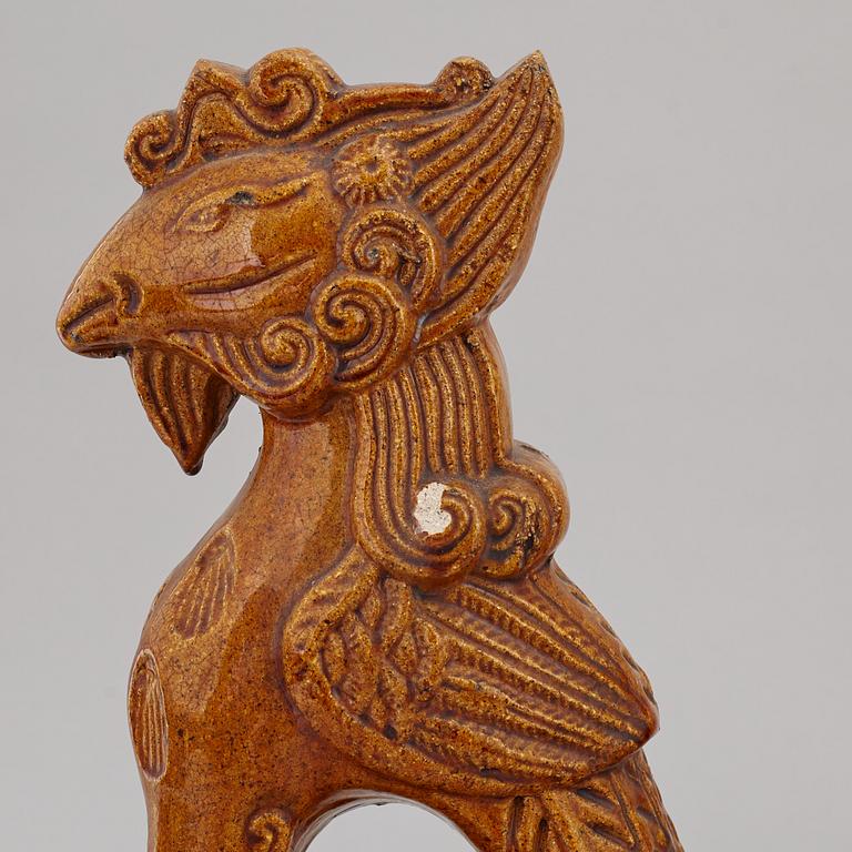 A group of three Chinese glazed roof tiles of seated animals, 20th century.