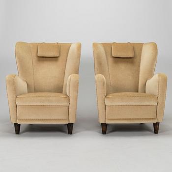 A pair of mid-20th century armchairs.