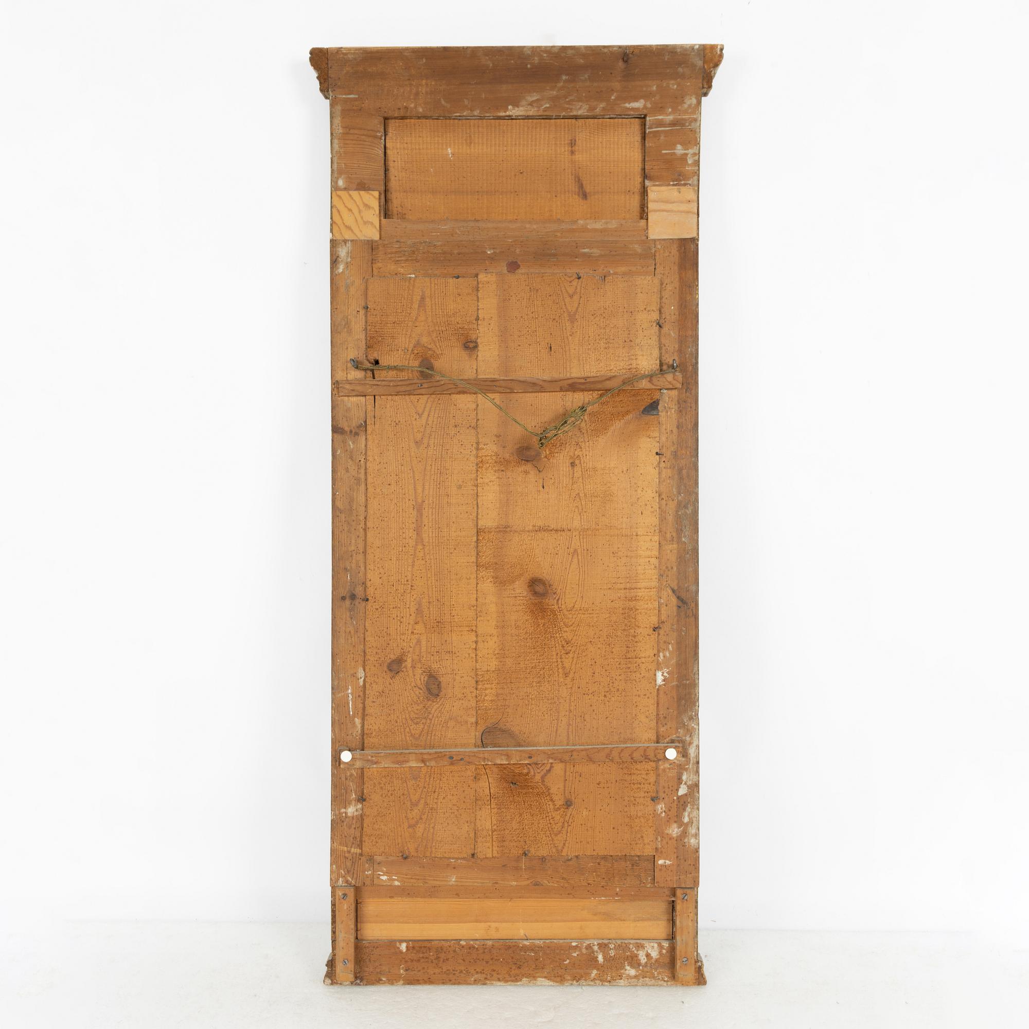 A late Gustavian giltwood and inset gouache mirror, circa 1800.