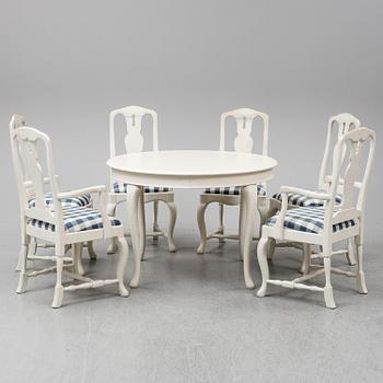 A rococo style dining table with 4+2 chairs.