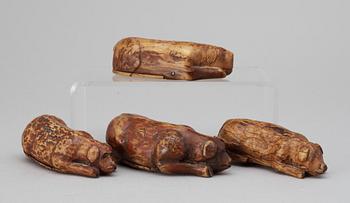 Four 19th-20th century birch snuffboxes i the shape of lying dogs.